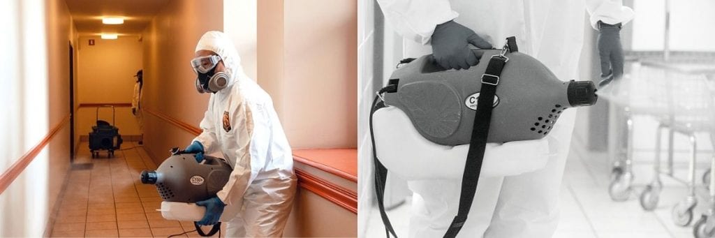 A Green Orchard Group team member uses an electrostatic fogging machine to disinfect an office.
