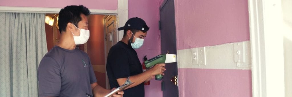 A team of Green Orchard Group Lead inspectors use XRF technology to examine an apartment for lead-based paint. 